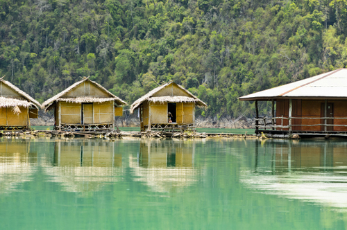 Small bungalows over water at Khao Sok National Park, Surat Thani Province, Thailand.