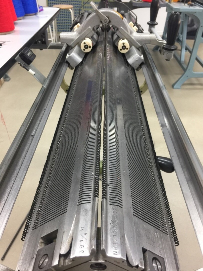 Hand driven flat knitting machine
