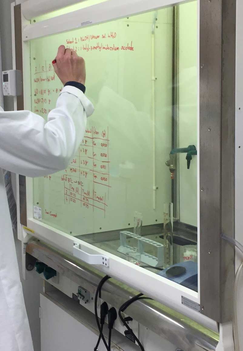 formula being written on a board