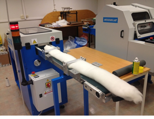roll of fibre being fed into a machine