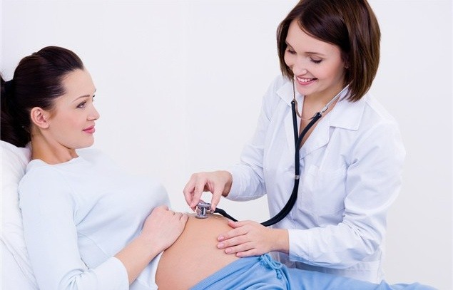 Midwife checking pregnant woman