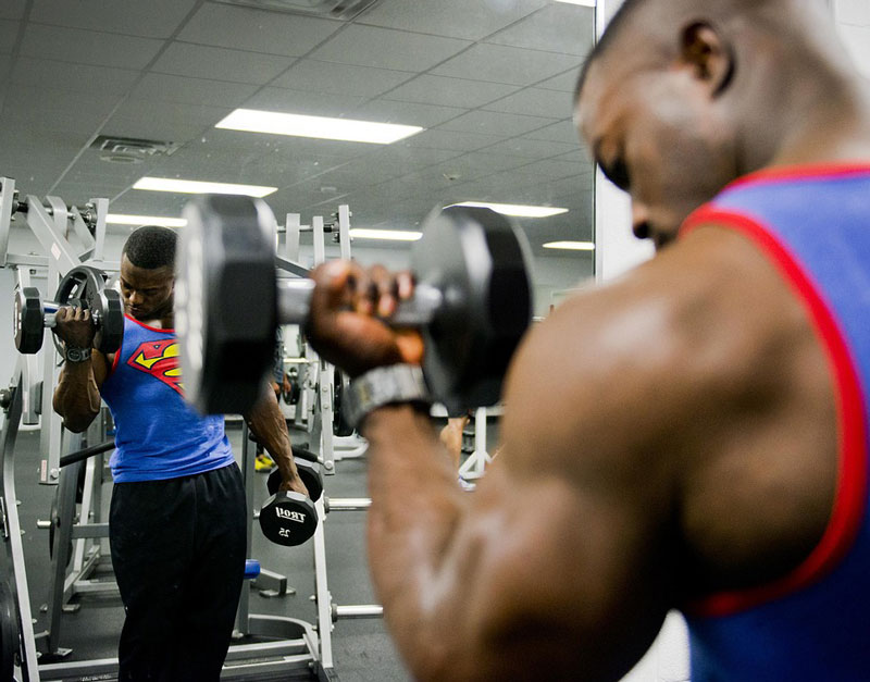 a male weight training in a gym